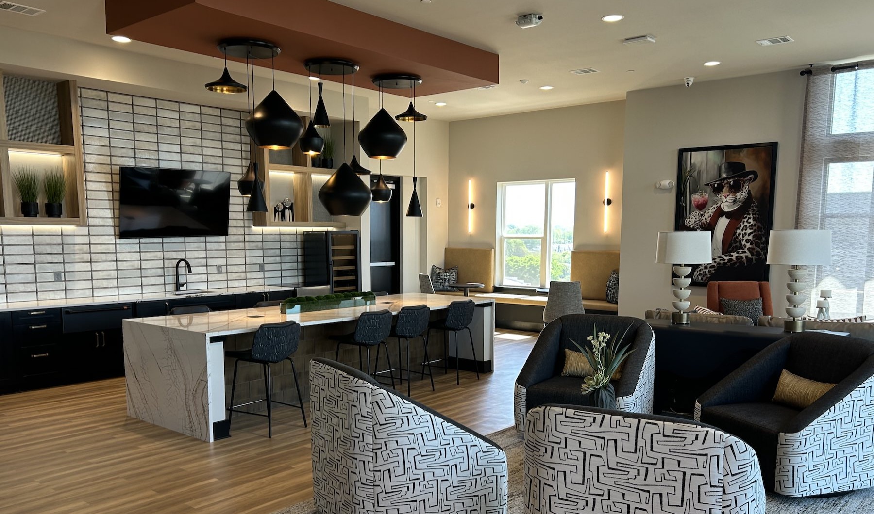 a lounge with a tv kitchen large island and seating